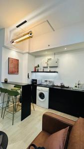 a kitchen with a counter and a table in a room at Pavilion Bukit Jalil Revo@Aurora By D'Summer91 in Kuala Lumpur