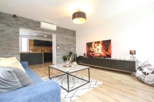 a living room with a couch and a fireplace at Apartmán Vita Deluxe in Trenčín