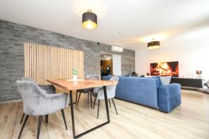 a living room with a table and a couch at Apartmán Vita Deluxe in Trenčín