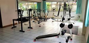 a room with a bunch of gym equipment on a tile floor at Venetian river view in Jomtien Beach