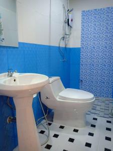 a blue and white bathroom with a toilet and a sink at Baan Chom Lay in Prachuap Khiri Khan +18 photos