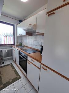 a small kitchen with white appliances and a window at Konstanzer Sonne 