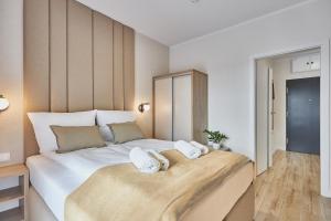 เตียงในห้องที่ Pelikan Apartments - Parking w cenie - Parkplatz inklusive