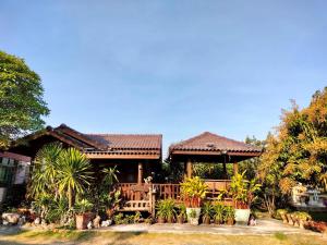 een huis met een veranda met planten ervoor bij Cool Cat House Resort 