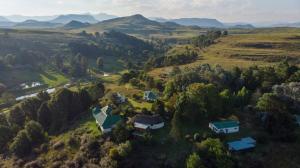 an aerial view of a house on a hill with mountains at Eagles' Rock in Underberg