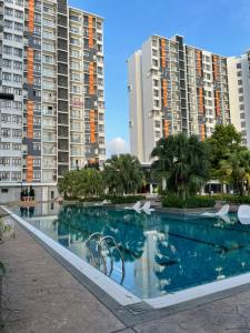 a swimming pool in front of some tall buildings at Timurbay Seafront Residence & Suites in Kuantan