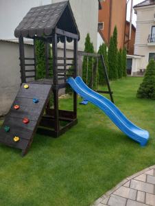 a playground with a slide in a yard at Royal Boutique in Râşnov