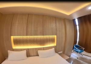 a bedroom with a bed with a light above it at Hotel Prago by Green Deer Varanasi in Varanasi
