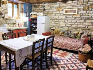 a kitchen with a table and chairs in a room at Alexana - Traditional House in Káto Figália