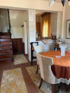 a room with a table and chairs and a kitchen at Villa Maron - Platanitis Beach in Maronia