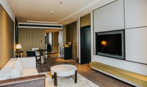 a living room with a large flat screen tv at Sheraton Xi'an South in Xi'an