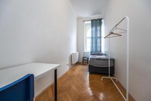 a room with a table and a bed in it at Vltava Apartments Prague 7 in Prague