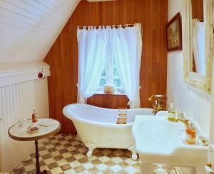a bathroom with a white tub and a sink at Villa Rospico - Plage de sable à 250m in Névez +37 photos