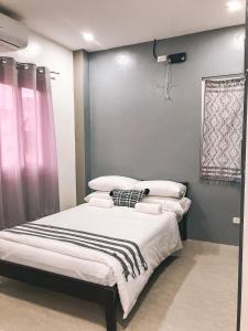 a bedroom with two beds with white pillows at 2 Bedroom Apartment Near The Beach in Bangcusay +4 photos