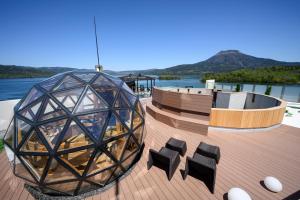 a deck with chairs and a glass dome on a boat at Akan Yuku no Sato Tsuruga in Akankohan