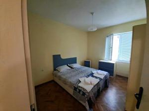 a small bedroom with a bed and a window at ALANA Apartment in Stara Zagora