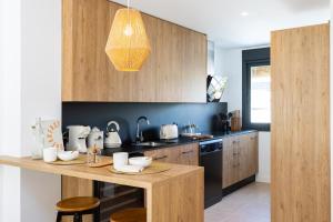 a kitchen with a counter with white dishes on it at Esencia Marbella Casas Boutique in Estepona