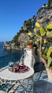 a table with a plate of food on a balcony at La Dolce Vita a Positano boutique hotel in Positano