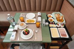 a table with breakfast foods and drinks on it at Casa da Marechal - Boutique Hotel by Oporto Collection - Adults Only in Porto