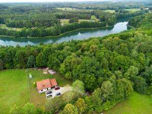 an aerial view of a house on a field next to a river at Apartament Mazurski Rodowo in Sorkwity