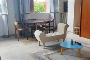 a living room with a table and chairs at Calm & New_Epinay-Le Bourget in Épinay-sur-Seine