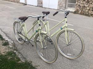 two bikes parked next to each other on the street at Small house at seafront in Tisno