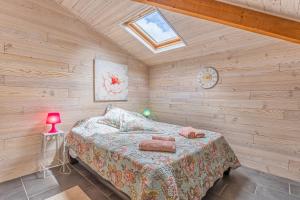 a bedroom with a bed in a room with wooden walls at Studio Bassin d'arcachon in La Teste-de-Buch