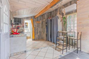 a kitchen with wooden walls and a table and chairs at Studio Bassin d'arcachon in La Teste-de-Buch