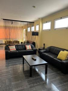 a living room with two couches and a coffee table at Casas de Luanda GH-Alvalade in Luanda