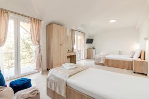 a bedroom with two beds and a large window at DE & EV ACCOMMODATION in Ohrid