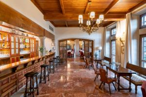 a restaurant with wooden ceilings and tables and chairs at Parador de Verín in Monterrei