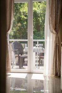 an open window with a view of a table and chairs at DE & EV ACCOMMODATION in Ohrid