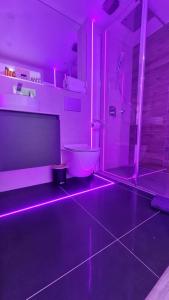 a bathroom with a toilet and a purple lighting at #6 TGHA Luxury Two Bedroom Apartment in Athlone in Athlone