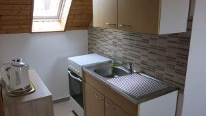 a small kitchen with a sink and a stove at Apartment Keszthely 10 in Bolgárkert