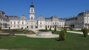 a large building with a fountain and a clock tower at Apartment Keszthely 10 in Bolgárkert