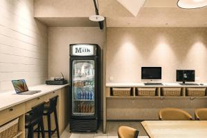 a drink refrigerator in a restaurant with a counter at Orange Hotel - Ximen, Taipei in Taipei