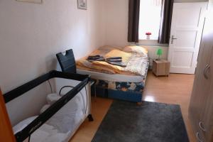 a small room with a bed and a window at Haus am Kroatenbach in Lautenthal