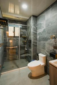a bathroom with a toilet and a shower at 墾丁包棟民宿-曜凱樂 in Hengchun +18 photos
