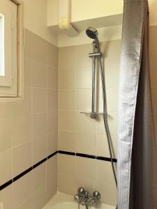 a bathroom with a shower and a tub at Traezh ar vag - Appartement Plage Perros-Guirec in Perros-Guirec