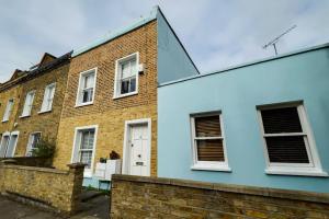 a house with blue paint on the side of it at 1 bed Townhouse in Battersea close to River Thames in London