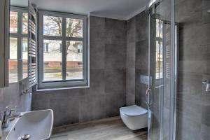 a bathroom with a shower and a sink and a toilet at Willa Perła in Ustka