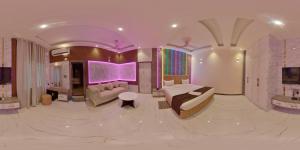 a bedroom with a bed and a couch in a room at Green Mapple in Muzaffarpur