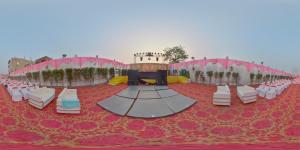 a banquet hall with tables and chairs on a red carpet at Green Mapple in Muzaffarpur