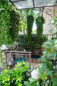a pergola with a table and some plants at La Guardia apartment with free private parking in Rijeka
