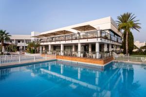 a building with a large swimming pool in front of it at Parador de Mojácar in Mojácar