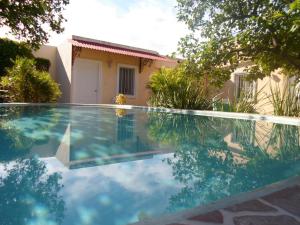 a swimming pool in front of a house at La Casa del Turix in Mérida