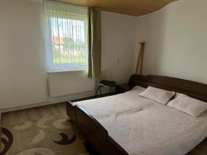 - une chambre avec un grand lit et une fenêtre dans l'établissement Közösségi ház, 