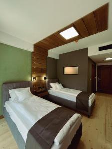 a hotel room with two beds in it at Pensiunea Senin in Sovata