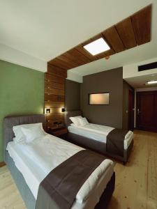 a hotel room with two beds in it at Pensiunea Senin in Sovata +63 photos