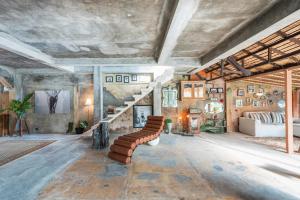 a living room with a couch and stairs in a room at The Corduroy Hotel in Canggu +78 photos